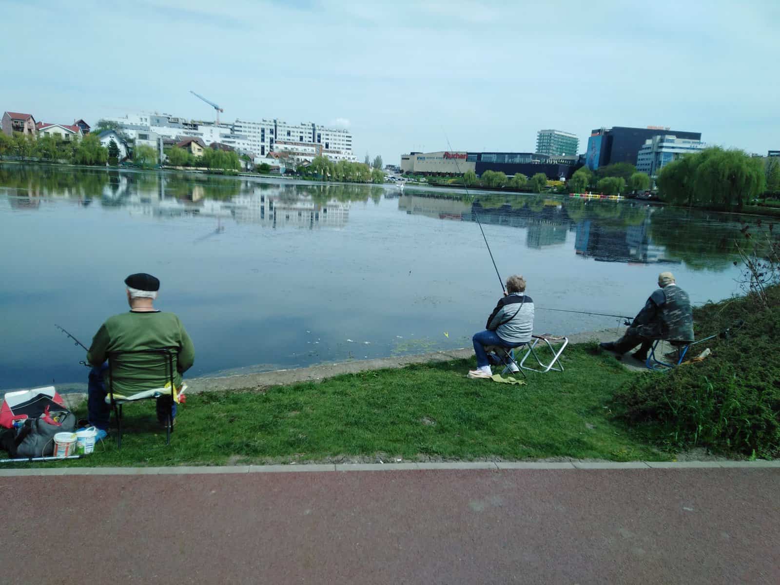 May be an image of 3 people and lake